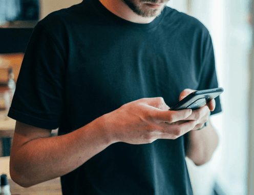 A man reading a message on his phone