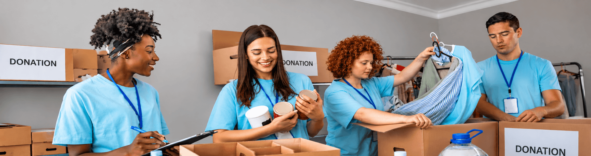 A group of volunteers sorting donated clothing and canned goods for a charity drive